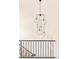 Modern chandelier hangs above a staircase with black railing and white walls at 350 Adams St, Denver, CO 80206