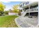 Backyard patio with a fire pit, stepping stones, landscaping and home's covered porch at 1311 Fletcher Dr, Erie, CO 80516