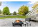 Backyard patio showing fire pit, outdoor seating, and lawn with professional landscaping at 1311 Fletcher Dr, Erie, CO 80516