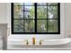 Beautiful bathtub with gold fixtures and a stunning outdoor view at 1311 Fletcher Dr, Erie, CO 80516