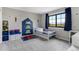 Cozy ' bedroom with built-in shelving, blue accents, and a large window for ample natural light at 1311 Fletcher Dr, Erie, CO 80516