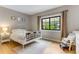 Cozy bedroom featuring natural light, hardwood floors, and neutral decor at 1311 Fletcher Dr, Erie, CO 80516
