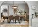 Elegant dining room with a wood table, stylish chairs, modern lighting, and archway views at 1311 Fletcher Dr, Erie, CO 80516