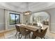 Bright dining room with hardwood floors, neutral decor, and backyard views at 1311 Fletcher Dr, Erie, CO 80516