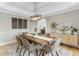 Dining room features a large table with decorative lighting, a sideboard, and hardwood floors at 1311 Fletcher Dr, Erie, CO 80516