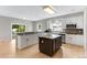 Modern kitchen with a granite island, ample counter space, and sliding doors at 1311 Fletcher Dr, Erie, CO 80516