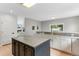 Open kitchen with a central island, lots of cabinet space, and an archway to living area at 1311 Fletcher Dr, Erie, CO 80516
