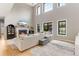 Bright living room featuring a fireplace, large windows, and a comfortable sectional sofa at 1311 Fletcher Dr, Erie, CO 80516