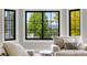 Comfortable living room featuring a large window with green backyard views and plush seating at 1311 Fletcher Dr, Erie, CO 80516