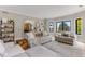 Inviting living room with soft, neutral furniture, hardwood floors and an archway at 1311 Fletcher Dr, Erie, CO 80516