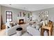 Elegant living room with a fireplace, hardwood floors, and stylish decor at 1311 Fletcher Dr, Erie, CO 80516