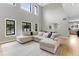 Spacious living room with high ceilings, large windows, and a sectional sofa at 1311 Fletcher Dr, Erie, CO 80516