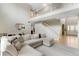 Open-concept living area showcasing a staircase and railing leading to the upper level at 1311 Fletcher Dr, Erie, CO 80516