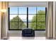 Bright home office with large window providing a peaceful view of mature trees and distant mountains at 1311 Fletcher Dr, Erie, CO 80516