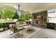 Charming covered patio featuring a stone fireplace, comfortable seating, and a serene outdoor living space at 1311 Fletcher Dr, Erie, CO 80516