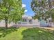 Spacious backyard featuring a well-maintained deck, lush green grass, and mature trees at 31 Shetland Ct, Highlands Ranch, CO 80130