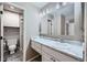 Well-lit bathroom featuring a white vanity with a marble countertop, plus shower at 31 Shetland Ct, Highlands Ranch, CO 80130