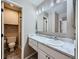 Well-lit bathroom featuring a marble vanity, stylish lighting, and an adjacent shower and toilet at 31 Shetland Ct, Highlands Ranch, CO 80130