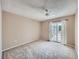 Spacious bedroom featuring neutral walls, carpet flooring, and a sliding glass door to a private balcony at 31 Shetland Ct, Highlands Ranch, CO 80130