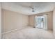 Bright bedroom features plush carpet, neutral walls, ceiling fan, and sliding glass door to private deck at 31 Shetland Ct, Highlands Ranch, CO 80130