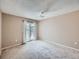 Spacious bedroom features a ceiling fan and sliding glass doors leading to a private balcony at 31 Shetland Ct, Highlands Ranch, CO 80130