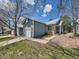 Charming exterior of a blue home featuring stone accents and well-maintained landscaping at 31 Shetland Ct, Highlands Ranch, CO 80130