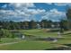 Beautiful golf course with lush green fairways, a tranquil pond, and blue skies at 31 Shetland Ct, Highlands Ranch, CO 80130