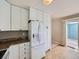 Bright kitchen with granite counters, white appliances, and access to the outdoor patio at 31 Shetland Ct, Highlands Ranch, CO 80130