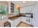 Well-lit kitchen with white cabinets, granite countertops, and modern appliances, ideal for cooking at 31 Shetland Ct, Highlands Ranch, CO 80130