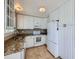 Efficient kitchen showcasing white cabinets, granite countertops, and modern appliances for functionality at 31 Shetland Ct, Highlands Ranch, CO 80130