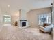Bright living room featuring a fireplace, neutral carpet, and ample natural light at 31 Shetland Ct, Highlands Ranch, CO 80130