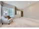 Bright living room featuring neutral colors, comfortable armchair, and lots of natural light at 31 Shetland Ct, Highlands Ranch, CO 80130