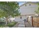 Back exterior of the home with a well-maintained lawn and stepping stone pathway at 4722 S Bannock St, Englewood, CO 80110