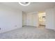 Bright bedroom featuring plush carpet, neutral walls, a closet, and access to the bathroom at 14076 E Radcliff Cir, Aurora, CO 80015