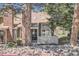 Inviting home exterior featuring a brick chimney and front entrance with stone landscaping at 14076 E Radcliff Cir, Aurora, CO 80015