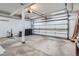 Spacious two-car garage interior featuring a garage door, ample parking, and storage space for vehicles and tools at 14076 E Radcliff Cir, Aurora, CO 80015