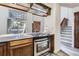 Cozy kitchen featuring stainless steel appliances and an inviting breakfast bar with stone countertops at 14076 E Radcliff Cir, Aurora, CO 80015