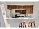 Eat-in kitchen with breakfast bar featuring stainless steel appliances, ample counter space and natural light at 14076 E Radcliff Cir, Aurora, CO 80015