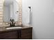 Elegant bathroom with a decorative mirror, dark wood vanity, and a modern sink at 2451 Lawrence St # 2, Denver, CO 80205