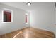Bright bedroom featuring two windows and hardwood floors, offering a minimalist and inviting space at 2451 Lawrence St # 2, Denver, CO 80205