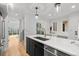 Bright, modern kitchen with stainless steel appliances, sleek island, and hardwood flooring at 2451 Lawrence St # 2, Denver, CO 80205