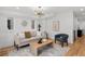 Bright living room with stylish furniture, modern lighting, and hardwood floors at 2451 Lawrence St # 2, Denver, CO 80205