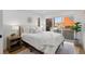 Bright main bedroom with large window, comfortable bed, and modern decor at 2451 Lawrence St # 2, Denver, CO 80205