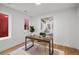 Office area features a wooden desk, minimalist decor, and natural light from the windows at 2451 Lawrence St # 2, Denver, CO 80205