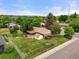 Aerial view of a home showing the fenced backyard, mature trees and proximity to surrounding neighborhood at 8198 E Lehigh Dr, Denver, CO 80237