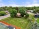 Aerial view of a large backyard with lush lawn, mature trees, and a partial view of the neighborhood at 8198 E Lehigh Dr, Denver, CO 80237