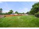 Well-maintained backyard with lush green grass and a wooden fence, offering a private and spacious outdoor area at 8198 E Lehigh Dr, Denver, CO 80237