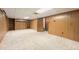 Finished basement with carpet and wood paneling, offering a versatile space at 8198 E Lehigh Dr, Denver, CO 80237