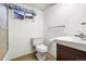 Bathroom with a white toilet, white sink, and classic decor at 8198 E Lehigh Dr, Denver, CO 80237