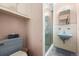 Compact bathroom with a unique blue sink and tiled walls, showcasing functional design at 8198 E Lehigh Dr, Denver, CO 80237